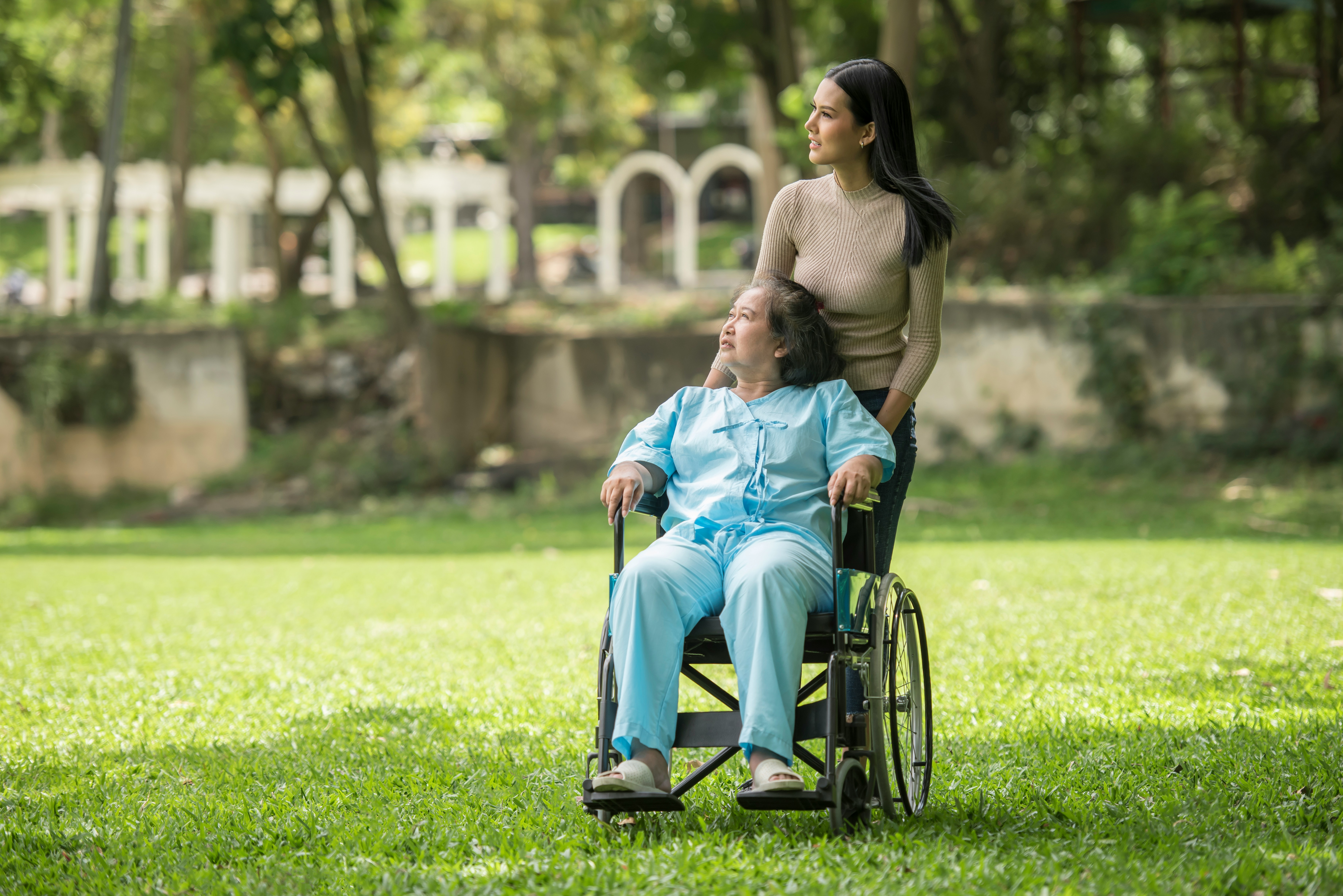 Caregiver supporting a client outdoors